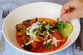 hand on plate of food
