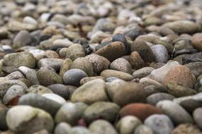 grey pebbles on beach close up, background