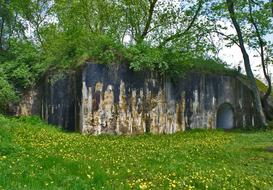 military bunker overgrown with grass