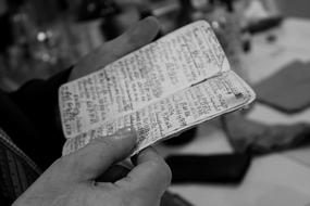 man reads notes in a notebook