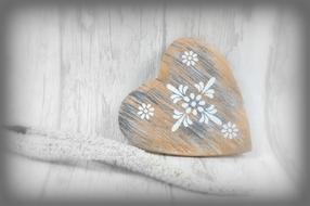 vintage wooden heart with white patterns