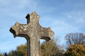 stone catholic cross in the cemetery