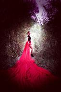 romantic photo of a girl in a long red dress
