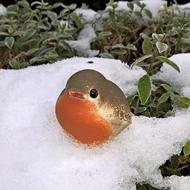 decorative figurine in the form of a bird in the snow