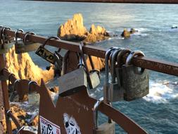 iron locks on the fence against the background of the sea