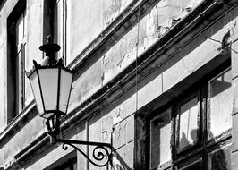 black and white photo of a street lamp on a historic building