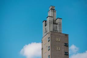 city gray tower against the blue sky