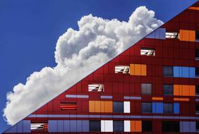 glass modern building on a background of clouds