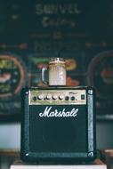 old amplifier speaker with a glass of coffee