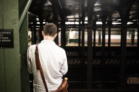 lonely man is waiting for a train at the station