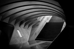 Black and white photo with the arches and stairs in the tunnel