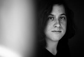 Black and white photo, with the portrait of the girl, with the freckles