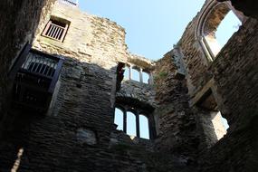 Beautiful, old ruins of the castle, in light and shadow, under the blue sky