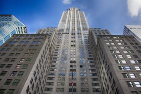 Low Angle view of office skyscraper with american flag on facade