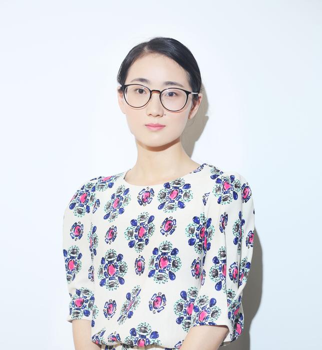 cute girl with glasses looks at the camera