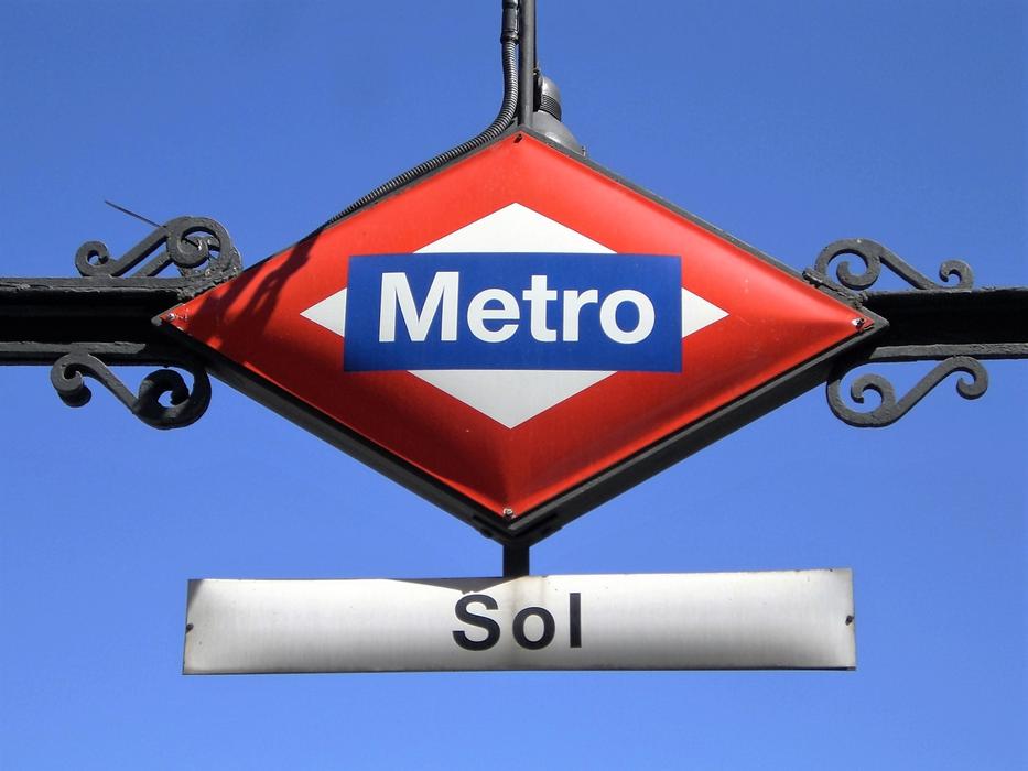 subway sign against the blue sky