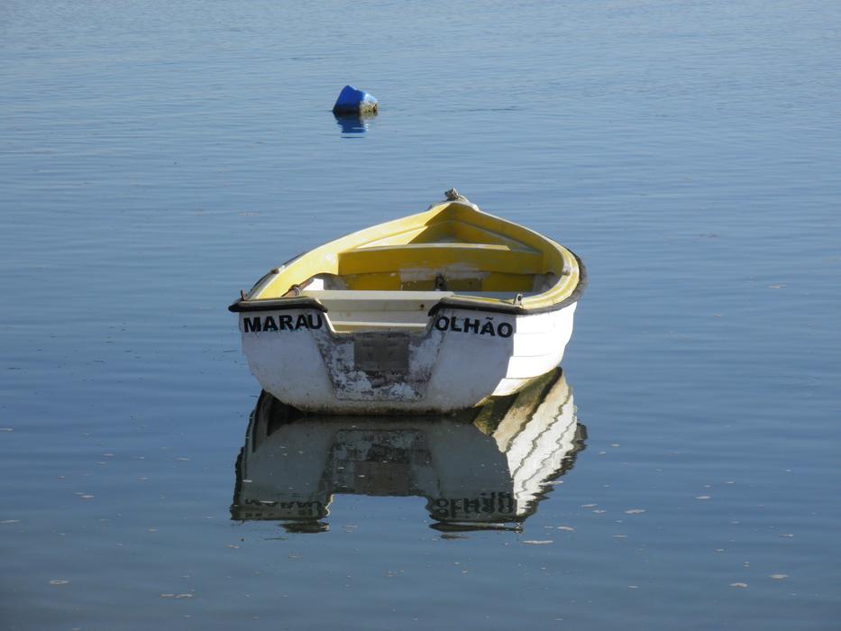 wooden boat sailing to a buoy