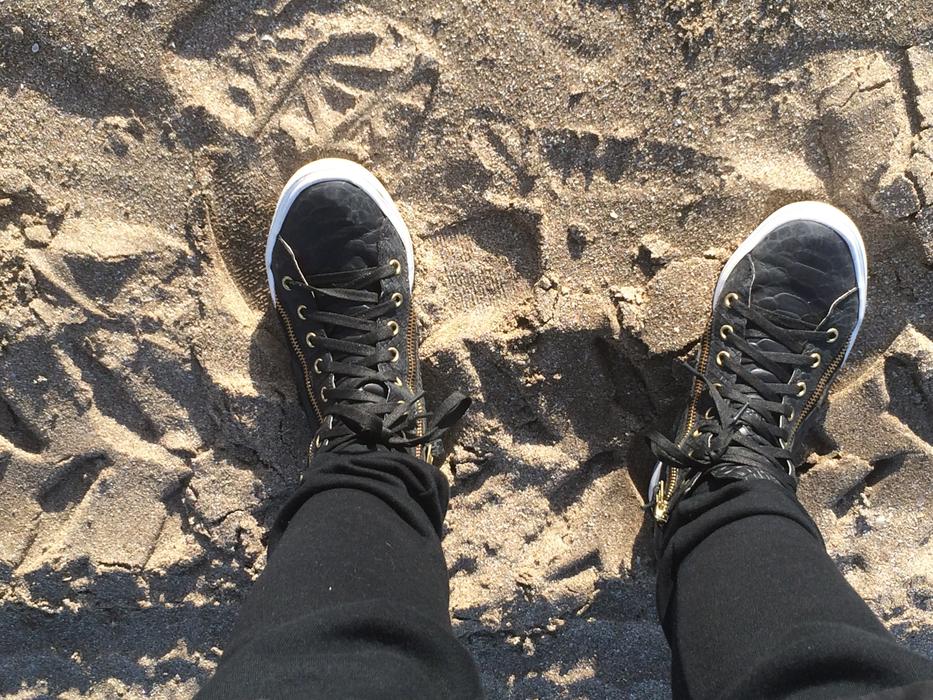 leather shoes on sand