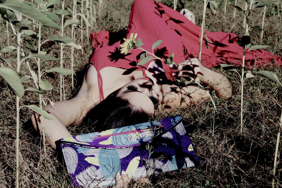 girl in a long dress lies in the grass