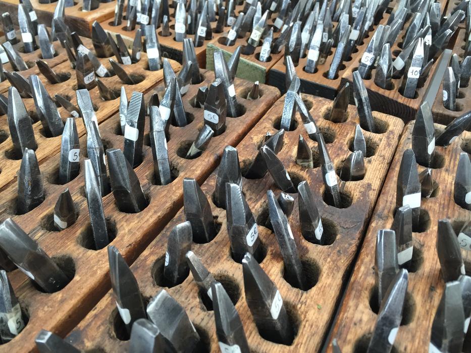 sharp metal iron in a wooden base