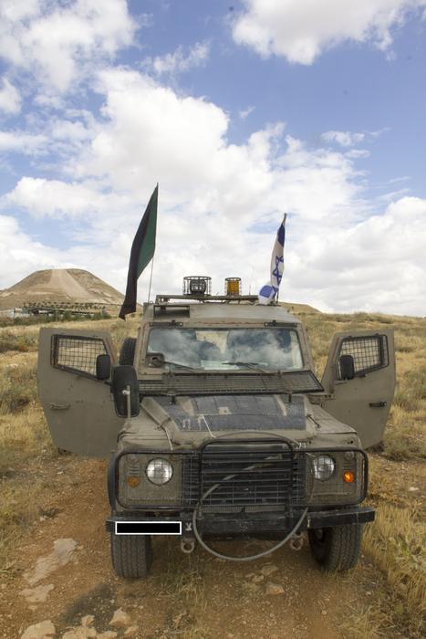 military vehicle with flags