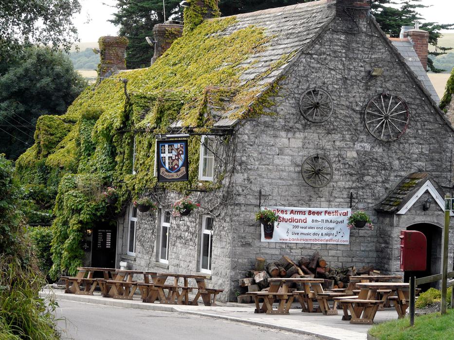 Beautiful, stone restaurant building with green and yellow plants in England