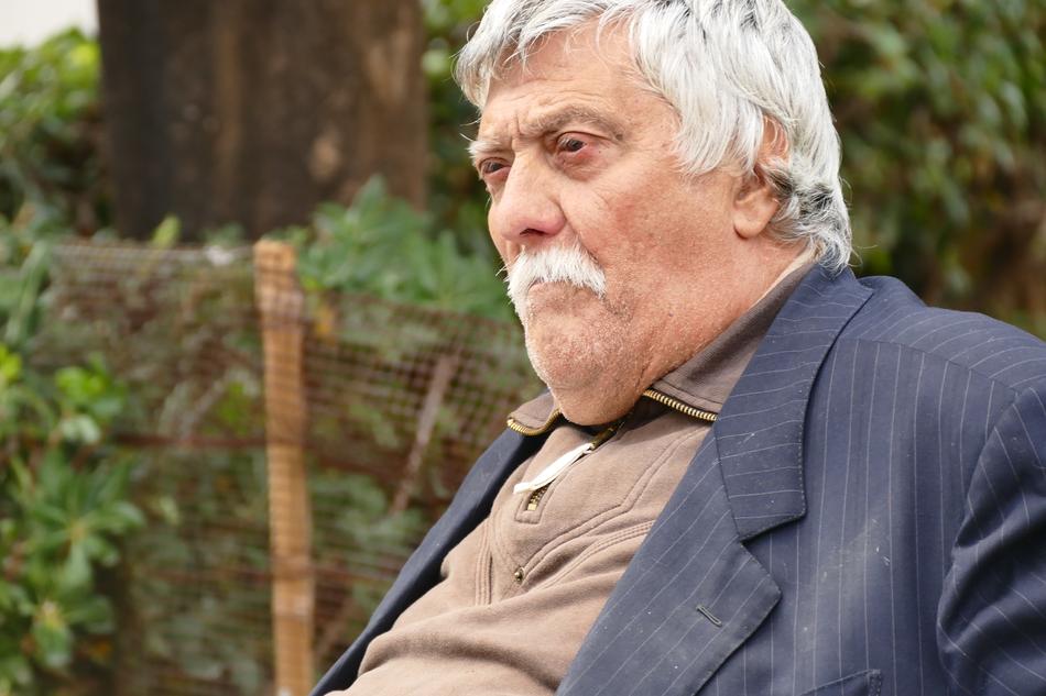 Portrait of the man, with white hair and moustache, among the plants in Sicily, Italy