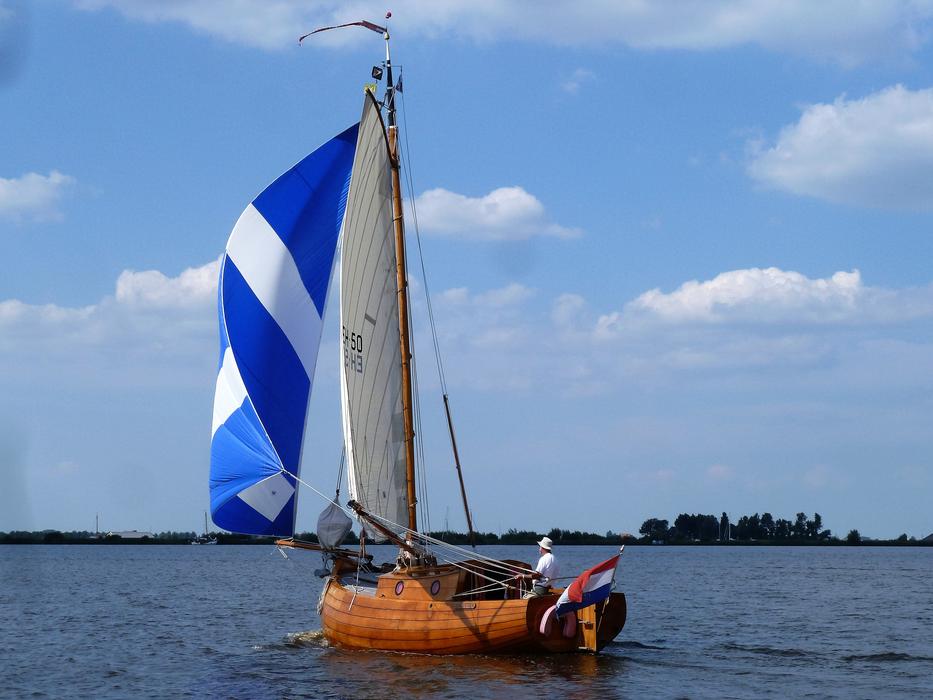 boat with blue and white sail