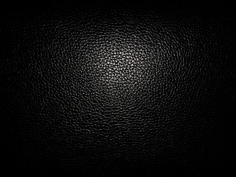 black leather background illuminated by light