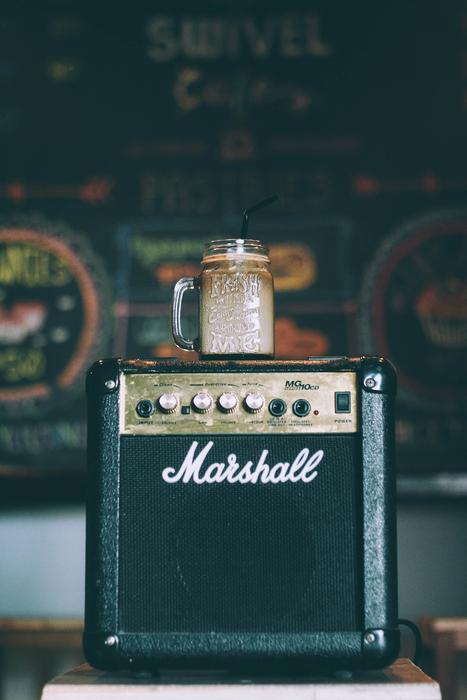 old amplifier speaker with a glass of coffee