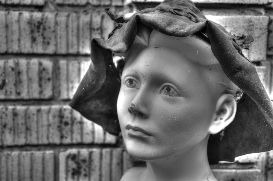 a sculpture of a child in a hat