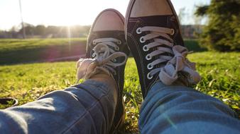 sneakers in jeans on a green background