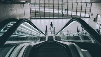 escalator in a large glass hall