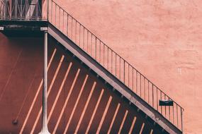 metal staircase on the facade of a red building