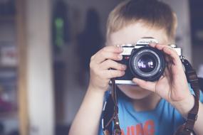 boy with camera in blurred background