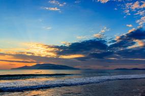 landscape of islands in sea at tranquil sunset