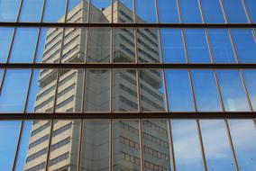 View of the building, with the windows, through the window, under the blue sky with white clouds
