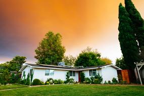 white village house on lawn at evening