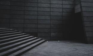 black and white photo of a stone staircase and building facade