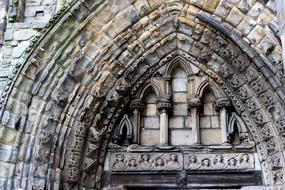 stone carving beneath Arch of Medieval Abbey close-up