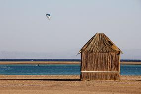 thatched hut on a sandy beach