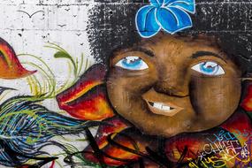 graffiti depicting a black child on the wall of a city building