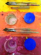 colorful table with brushes and glasses