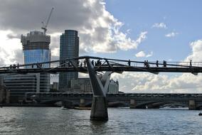 People on the beautiful bridge at cityscape of London, England, UK