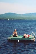 people on the lake pontoon