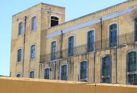 Beautiful, old, yellow building at blue sky in Faro, Portugal