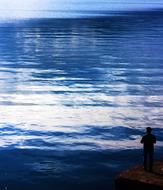 silhouette of a man by the ocean