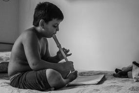 Boy Playing Flute in black and white background