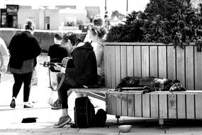 man with guitar on city street in black and white background