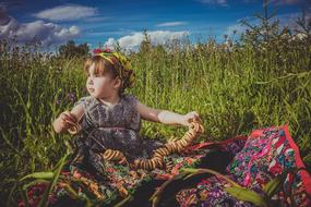cute baby sitting in the grass